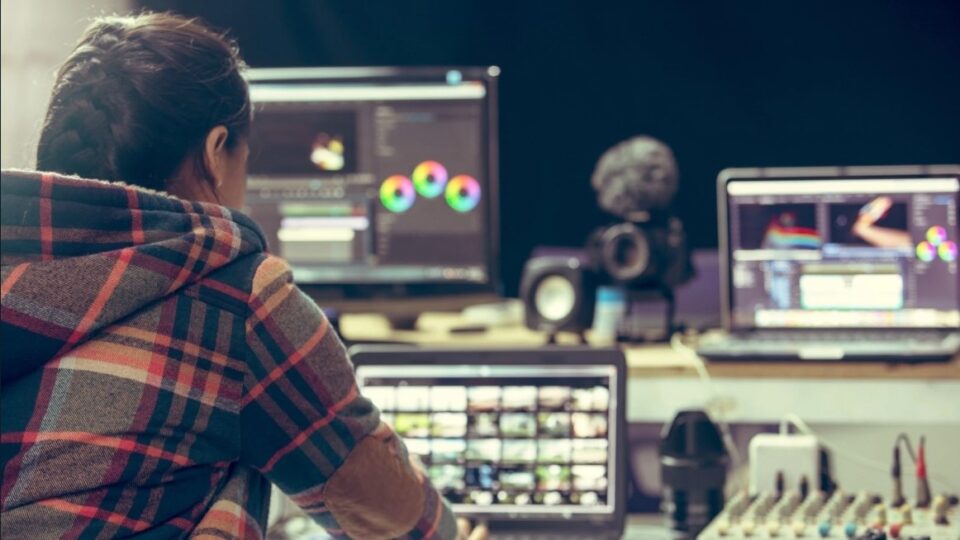 A person looking over an AV equipment bank.